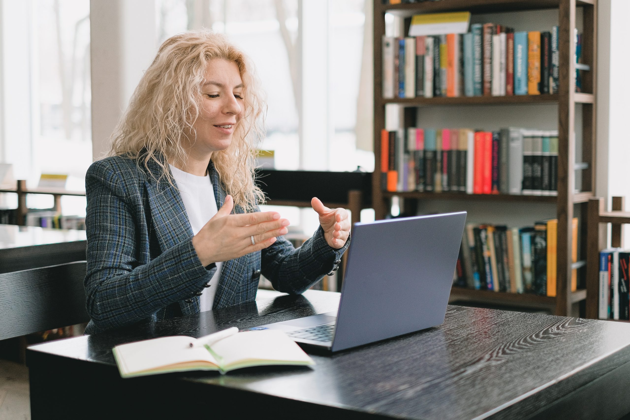 woman working remotely on laptop in an online meeting